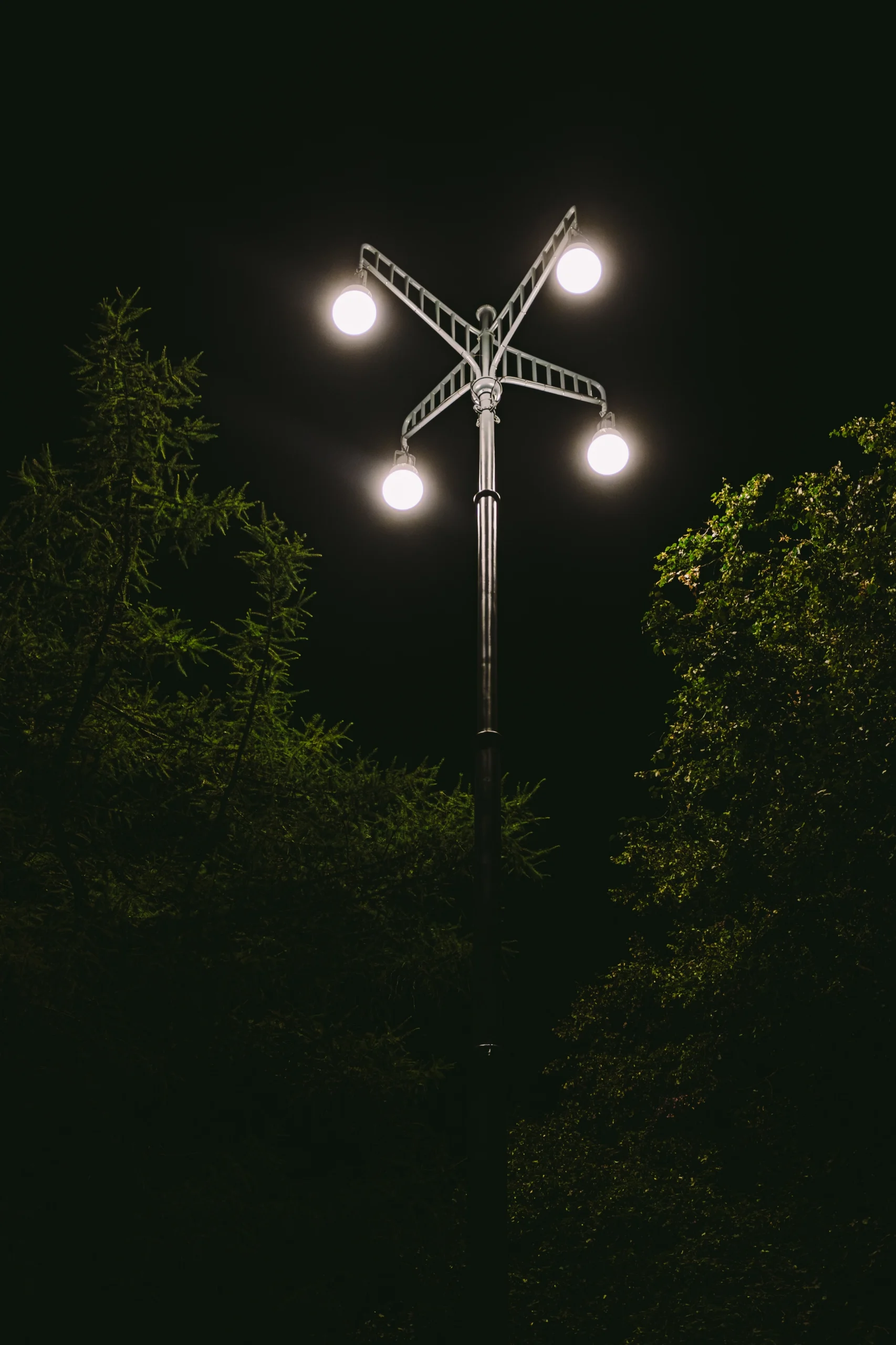 A view from the ground up to a LED outdoor park lighting at night