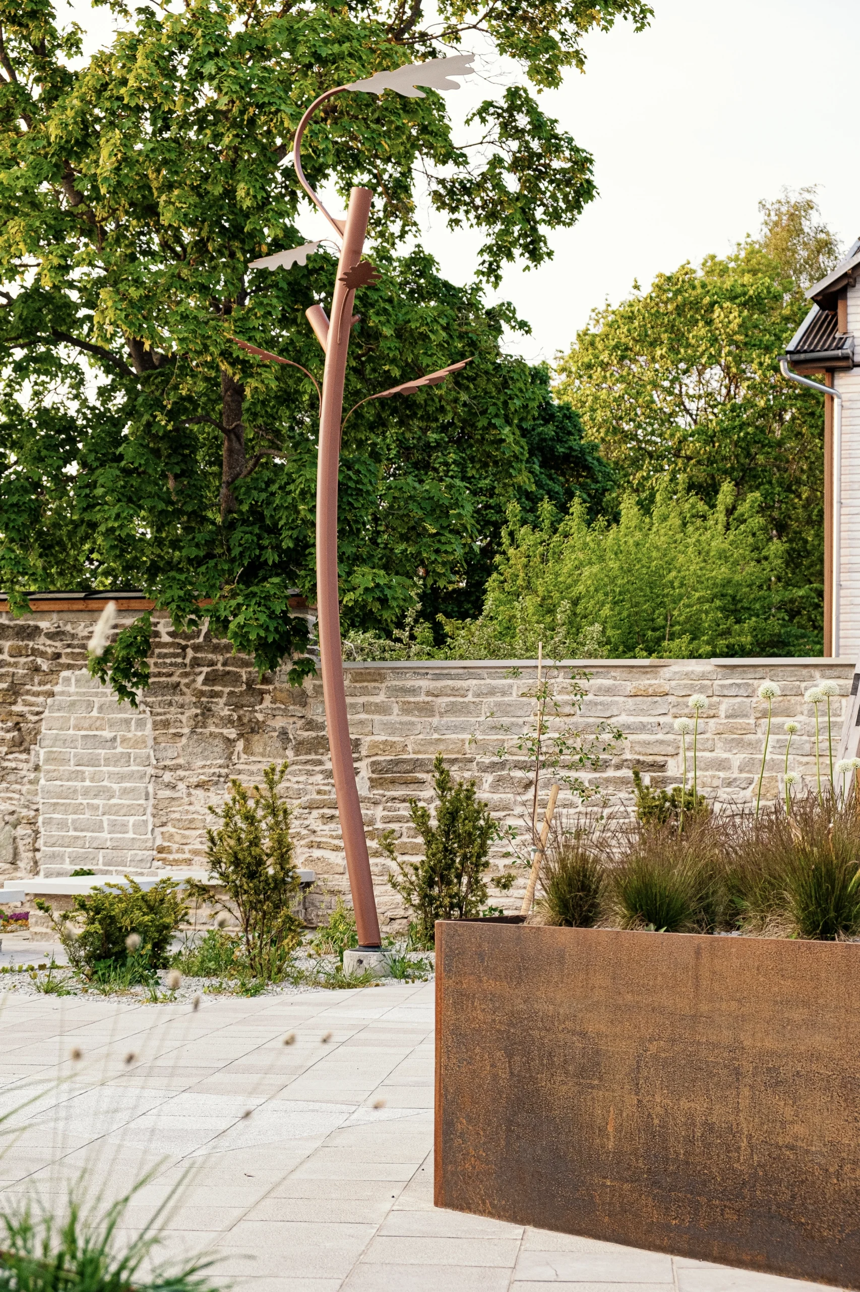 Custom oak tree-inspired outdoor lighting fixture installed in a public park.