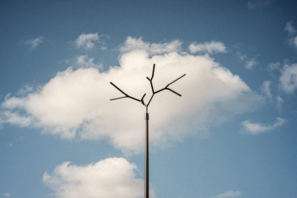 Tree-branch form of the Branch luminaire silhouetted against clouds, Paju, Tartu