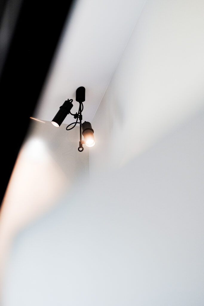 Residential corridor in Pärnu lit by Lightweight industrial pendants