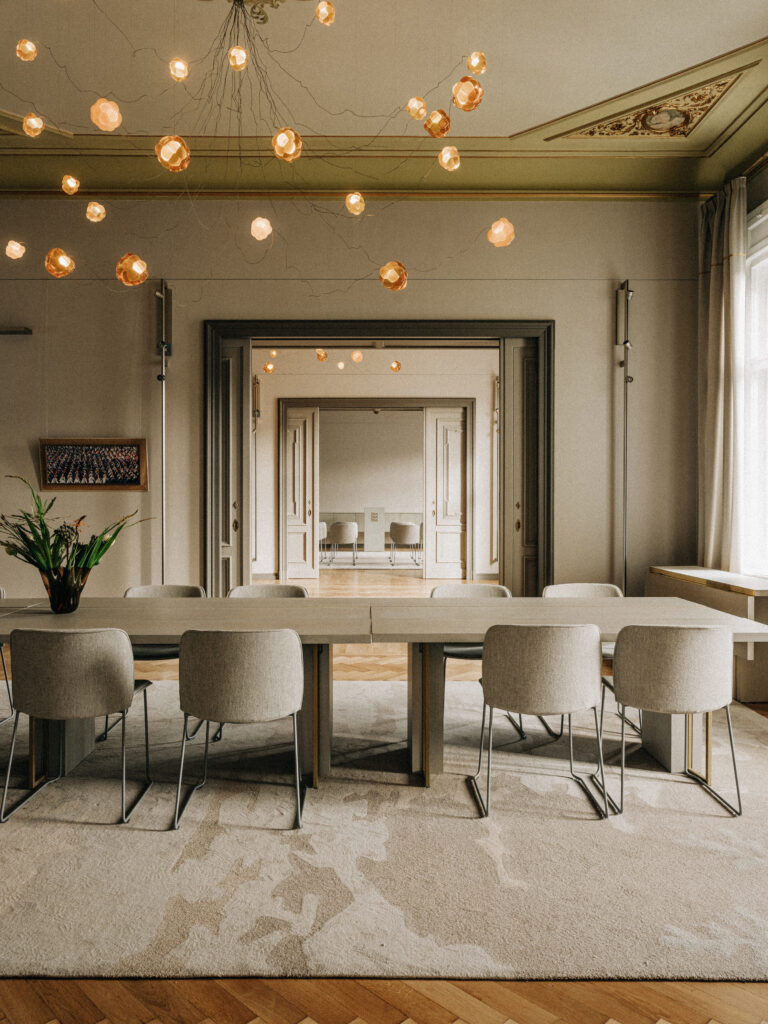 Cloudberry custom resin chandelier over a dining table beneath a painted ceiling, Berlin