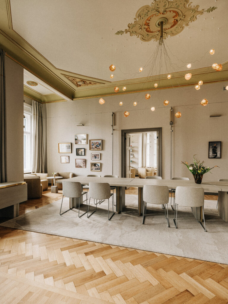 Cast resin Cloudberry lights above a herringbone floor and dining table, Estonian Embassy in Berlin