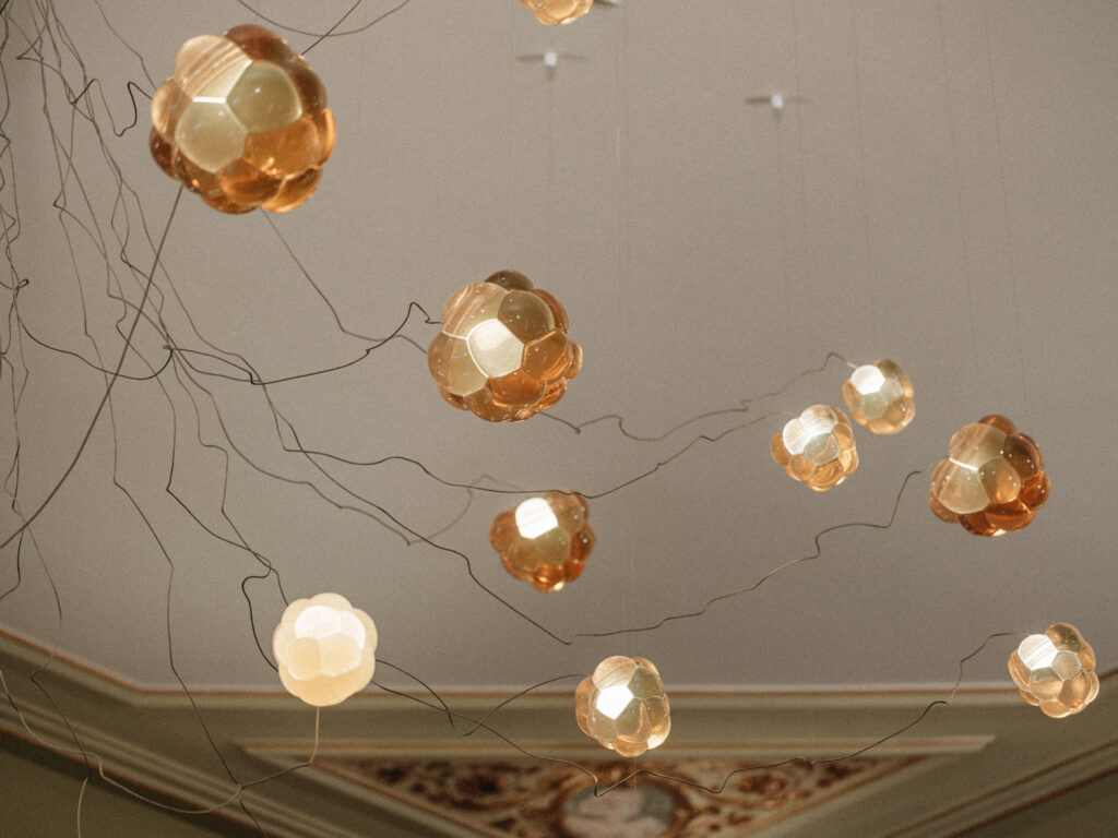 Amber cast resin Cloudberry pendants on fine cables at varying heights, Berlin