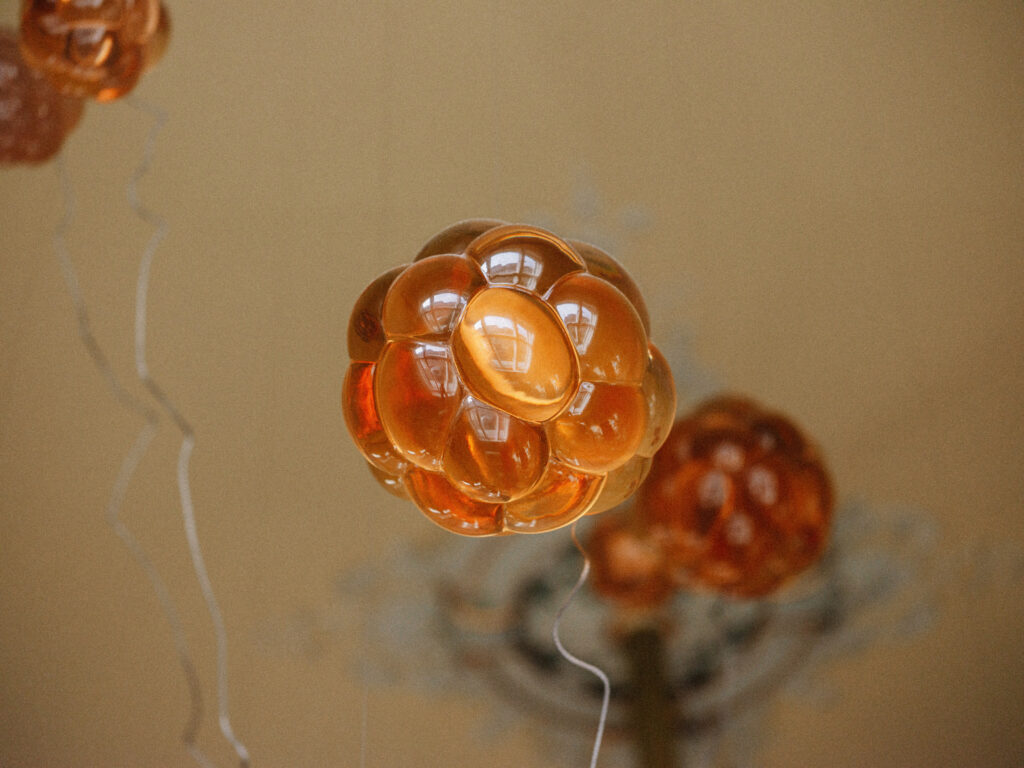 Single amber cast resin Cloudberry form in close detail, Estonian Embassy in Berlin