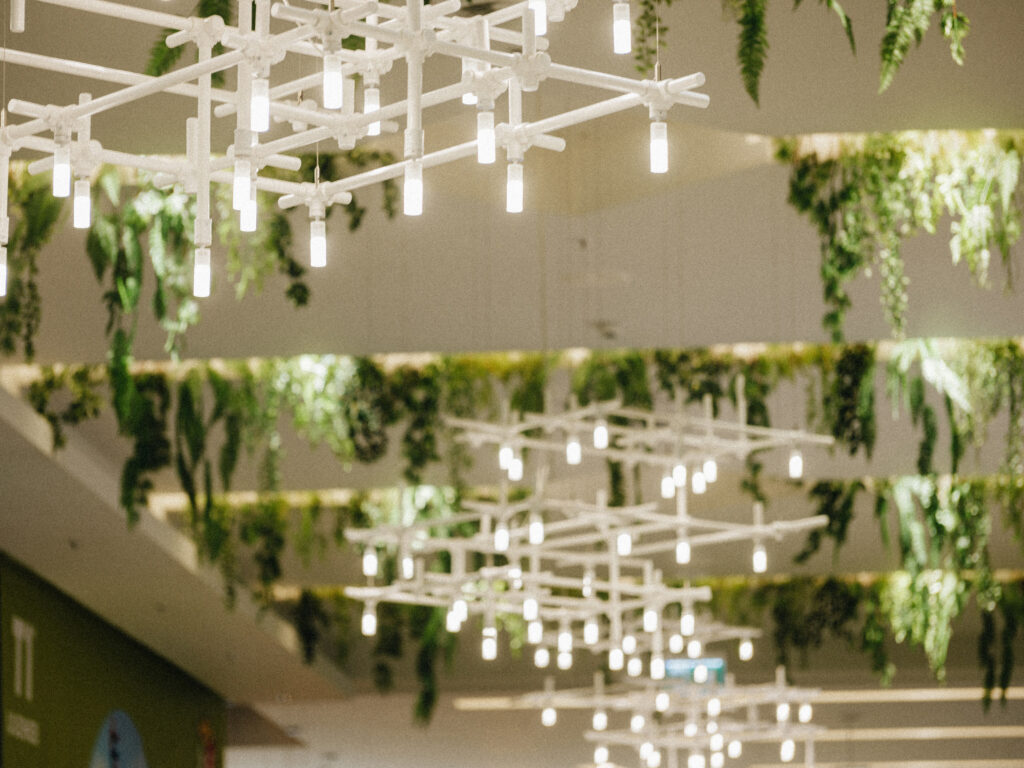 HEXA modular chandelier installation with hanging greenery over the T1 Mall walkway, Tallinn