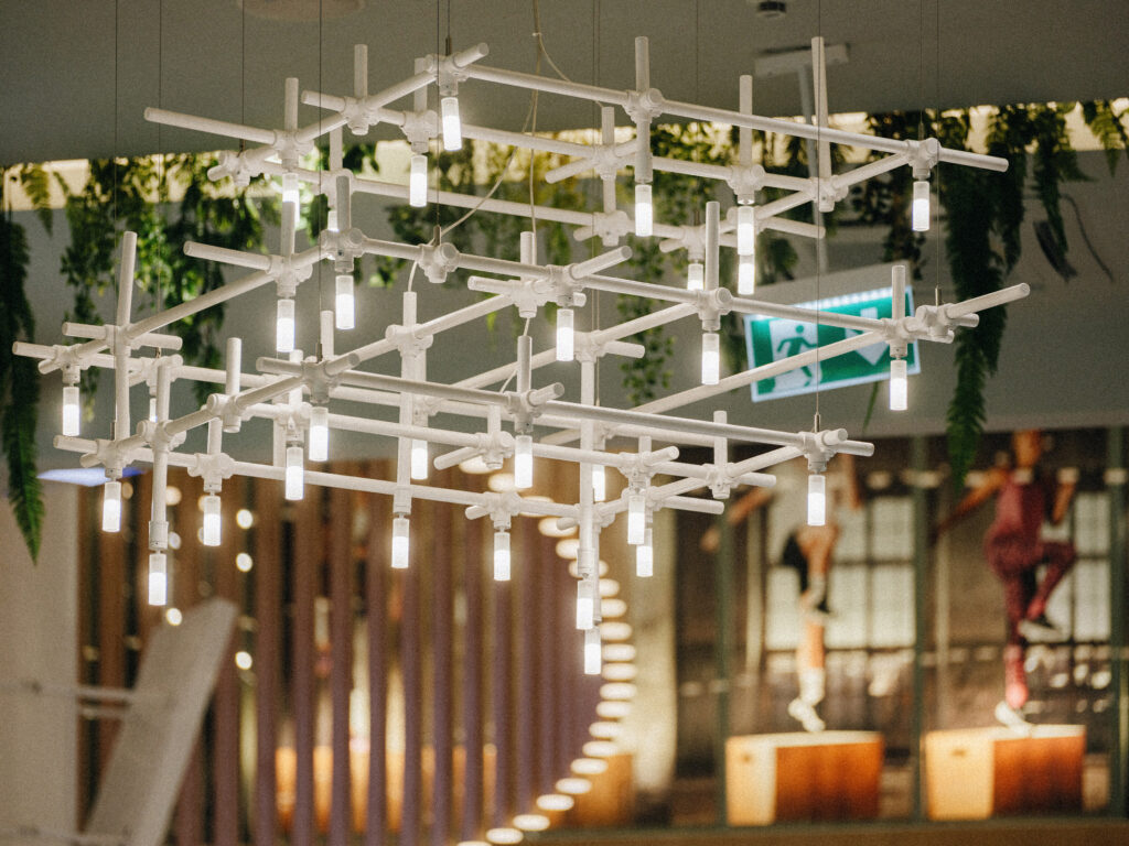 HEXA modular grid chandelier with glowing LED tubes over the T1 Mall, Tallinn