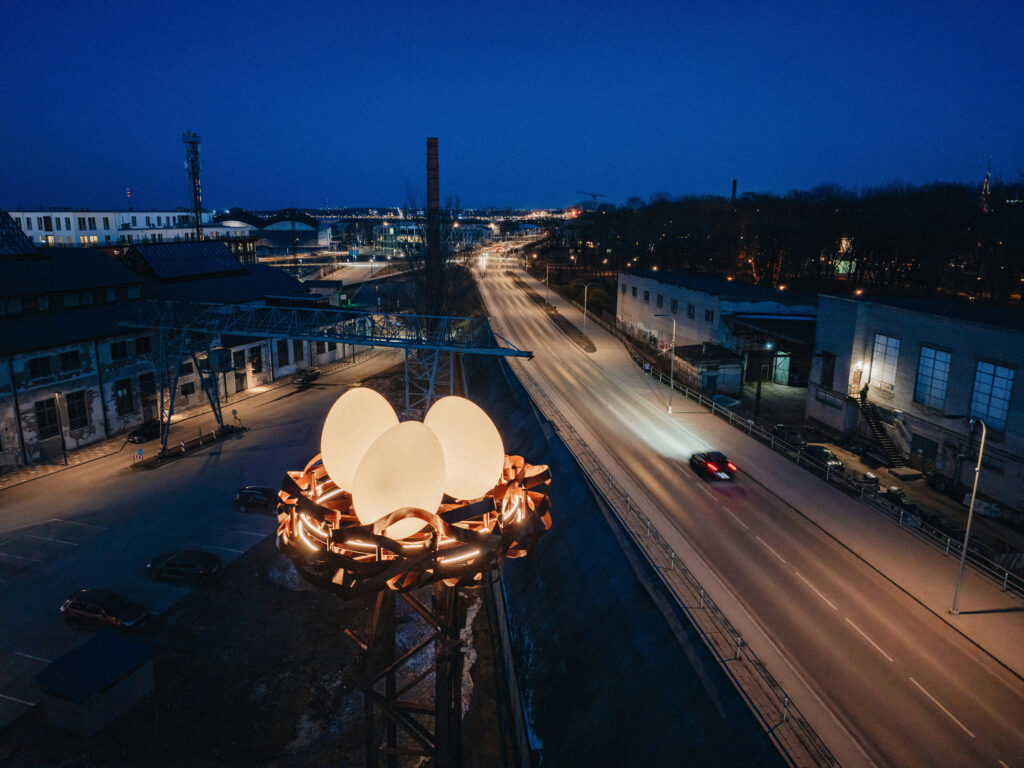 Nest custom light installation with glowing eggs on a lattice tower at dusk, Noblessner, Tallinn