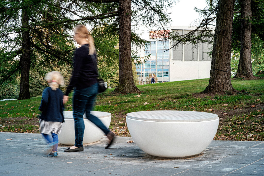 Mother and child walk past a Timpan bench near the Vanemuine theatre, Tartu