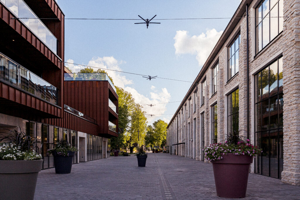 Blackbird catenary lighting in Tallinn, four lights strung over the street between Corten steel and old limestone walls